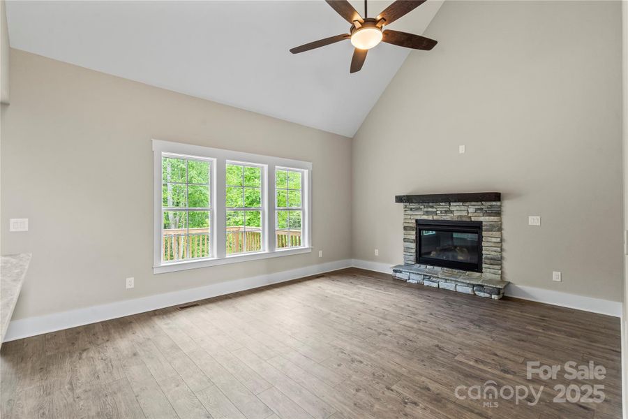 Great room with stone fireplace & vaulted ceiling Great room with stone fireplace & vaulted ceiling