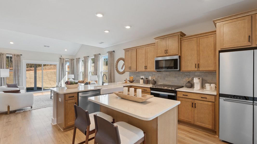 Superior craftsmanship shines in this modern kitchen with a space-saving island and open flow at Barton Hollow