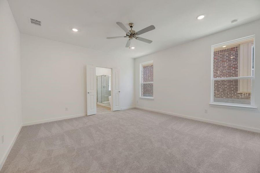 Spare room with light carpet, recessed lighting, and ceiling fan