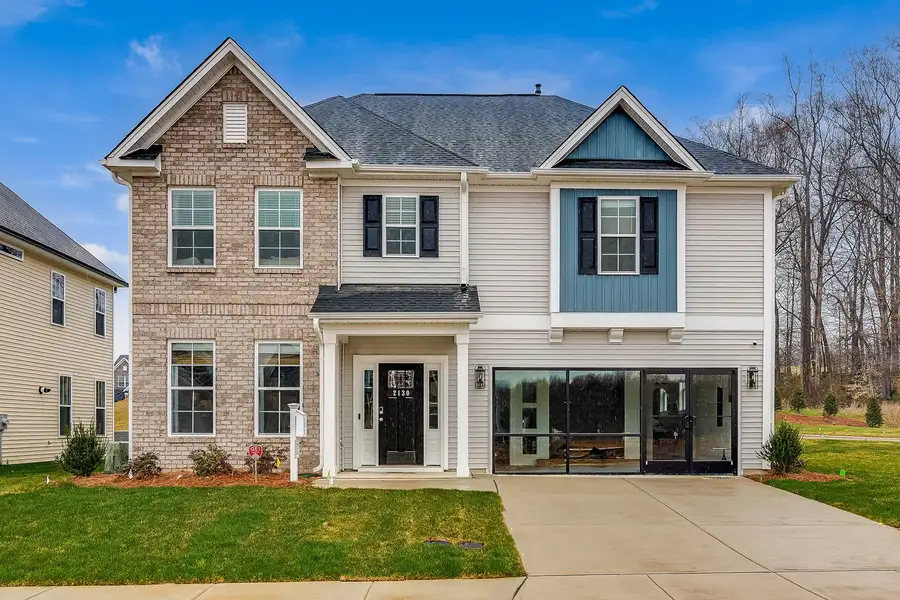 Front exterior of a new home in Hanes Lake, Winston-Salem, NC, highlighting curb appeal (Image 1). Front exterior of a new home in Hanes Lake, Winston-Salem, NC, highlighting curb appeal (Image 1).