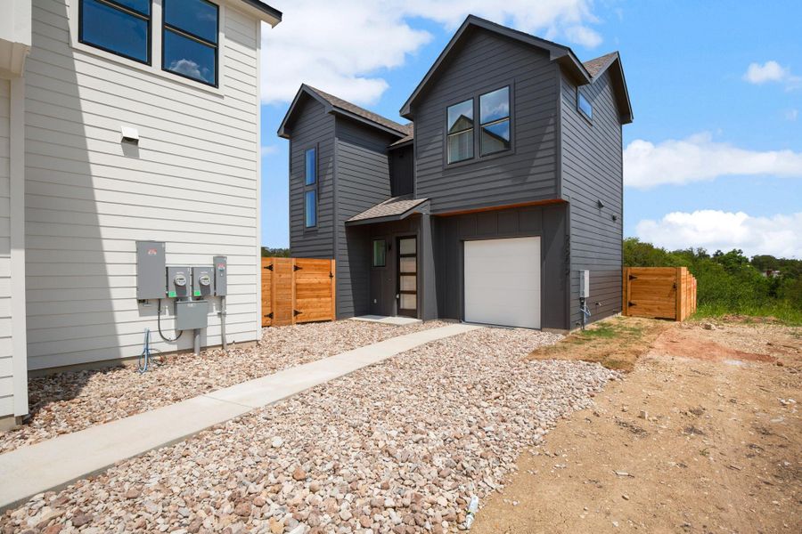 Contemporary home with a garage, driveway, and a shingled roof Contemporary home with a garage, driveway, and a shingled roof