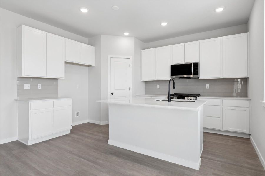 A kitchen with white cabinets. A kitchen with white cabinets.