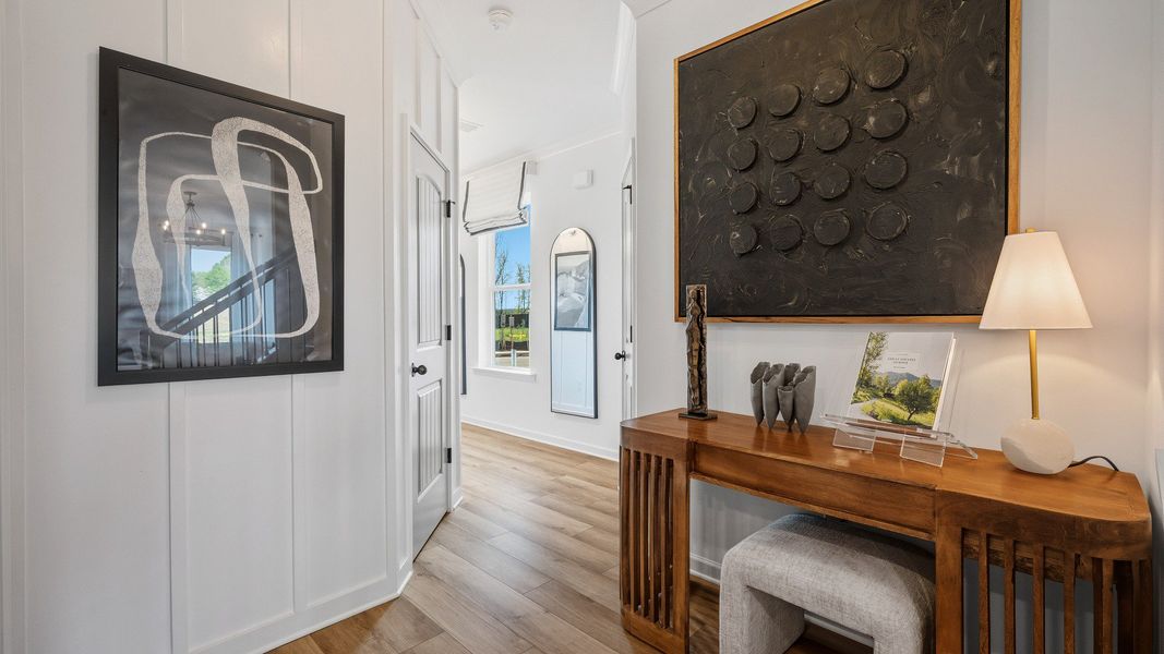 Bright foyer with LVP flooring and room for entryway table in new construction townhome in Loganville, GA.