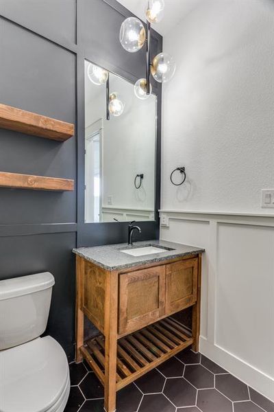 Bathroom with vanity, toilet, and tile patterned floors