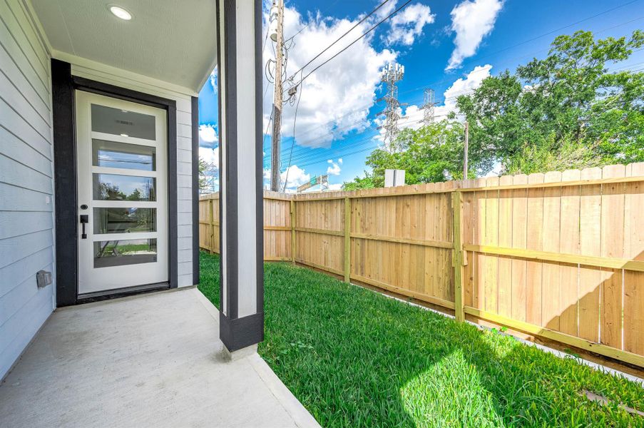 Fenced backyard space with lush green grass—perfect for pets, outdoor lounging, or creating your own private outdoor retreat.