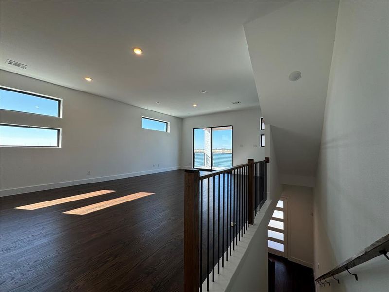 Empty room with dark hardwood / wood-style floors