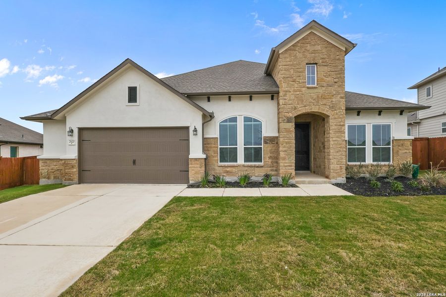 Front exterior of a new home in Homestead, Schertz, TX, highlighting curb appeal (Image 2). Front exterior of a new home in Homestead, Schertz, TX, highlighting curb appeal (Image 2).