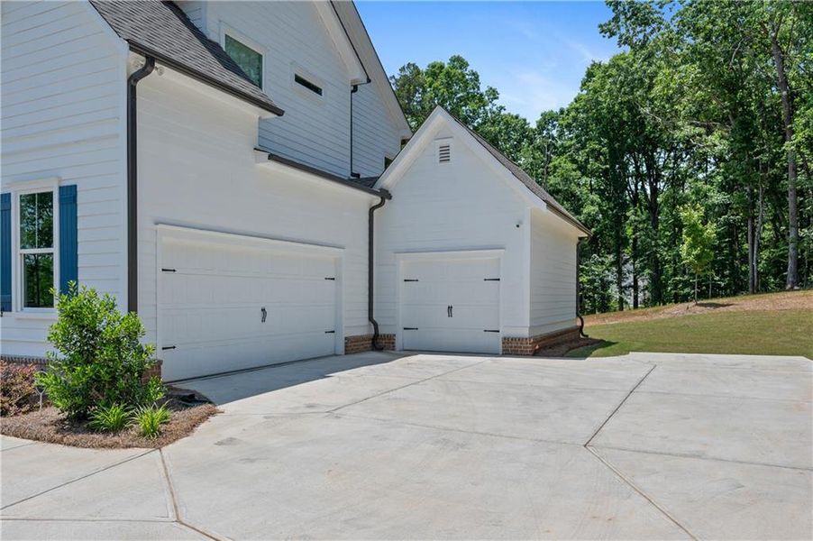 Front exterior of a new home in , Cumming, GA, highlighting curb appeal (Image 24).