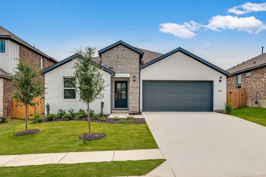 Representative exterior photo of a completed home built from the Mockingbird by Taylor Morrison in Longview 50s, Del Valle, TX (Image 1).