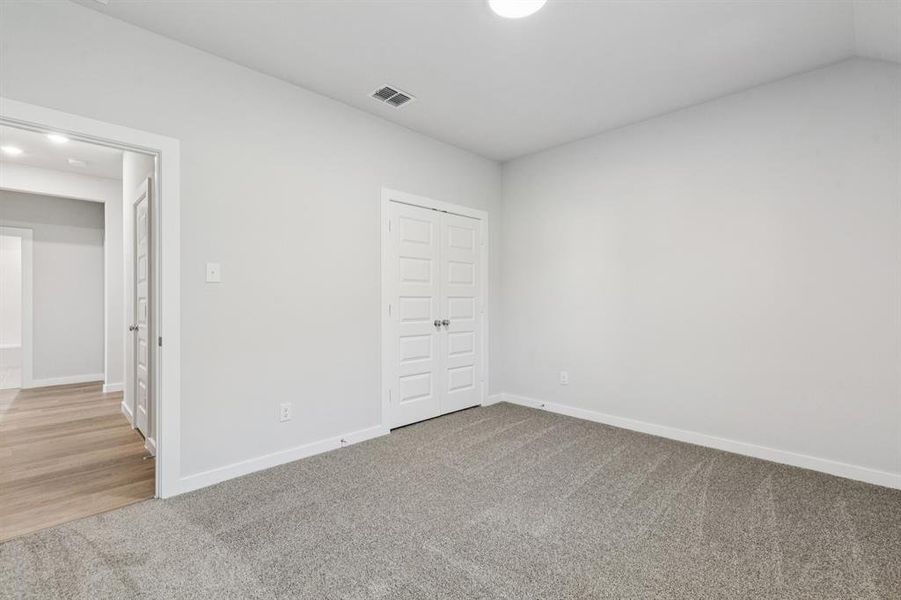 Bedroom in the Oscar home plan by Trophy Signature Homes – REPRESENTATIVE PHOTO