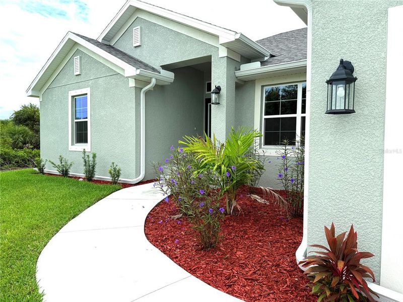 Front exterior of a new home in South Gulf Cove, Port Charlotte, FL, highlighting curb appeal (Image 19).