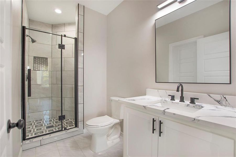 Full bathroom featuring vanity, light tile patterned floors, and a shower stall Full bathroom featuring vanity, light tile patterned floors, and a shower stall
