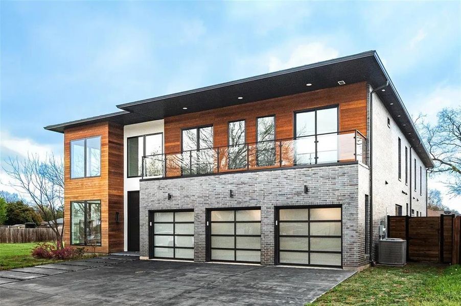 Modern multi-level exterior with wood paneling and grey brick accents Modern multi-level exterior with wood paneling and grey brick accents