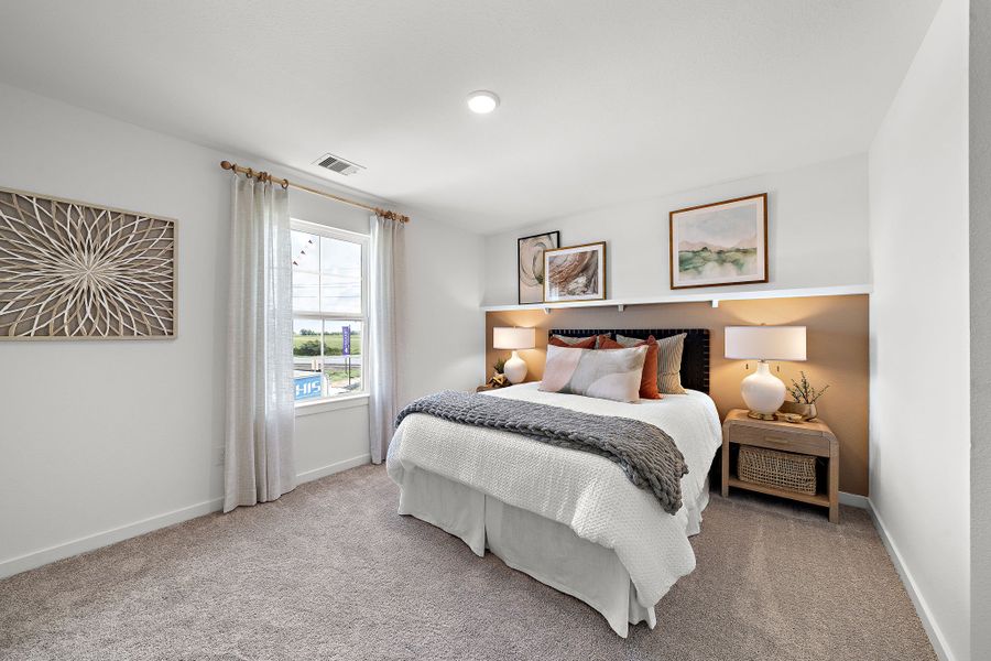 A bedroom with a bed and lamps. A bedroom with a bed and lamps.