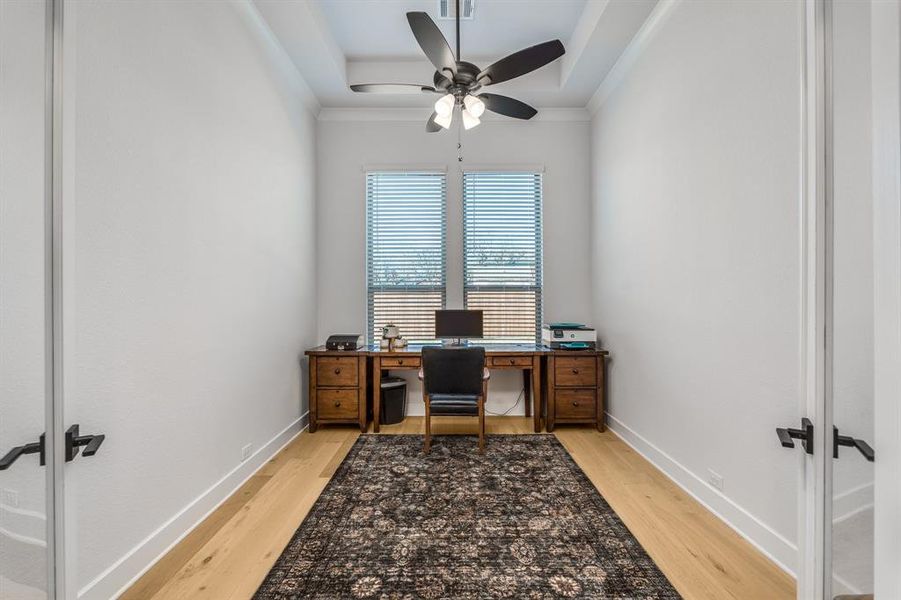 Office area featuring ceiling fan, hardwood / wood-style floors, french doors, and ornamental molding