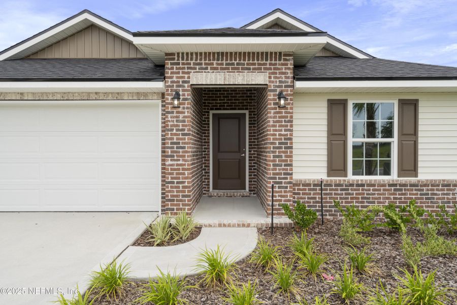 Front exterior of a new home in Shadow Crest at Rolling Hills, Green Cove Springs, FL, highlighting curb appeal (Image 1).