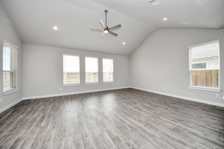 Welcome family and guests to your charming living room! With its high ceilings,recessed lighting, ceiling fan, custom paint, beautiful flooring, and large windows that letin abundant natural light, this room is perfect for gatherings.