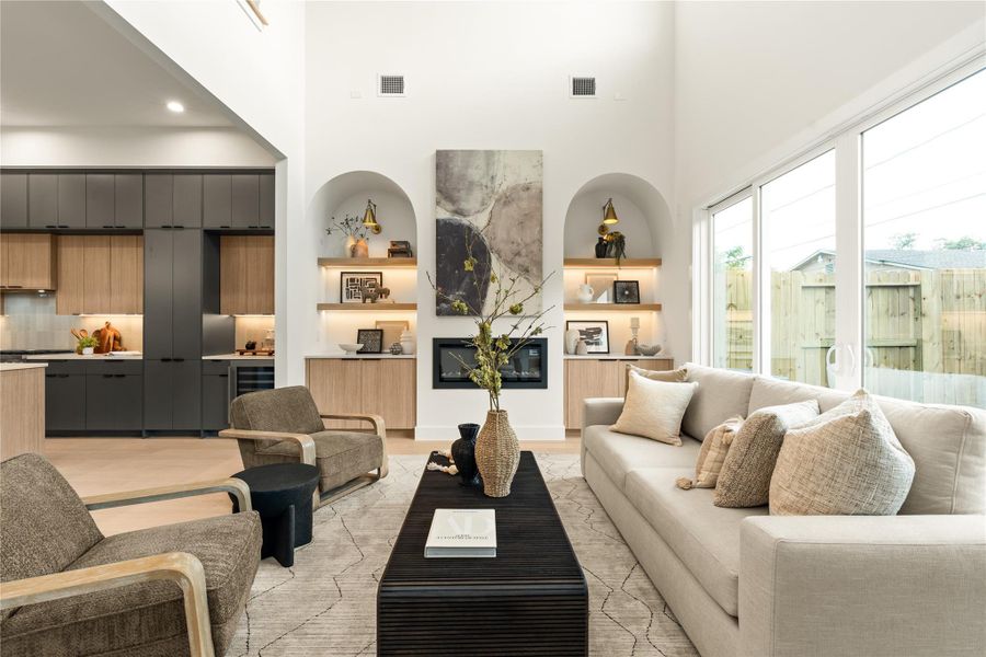 This living room includes a fireplace and two beautifully arched nooks. This living room includes a fireplace and two beautifully arched nooks.