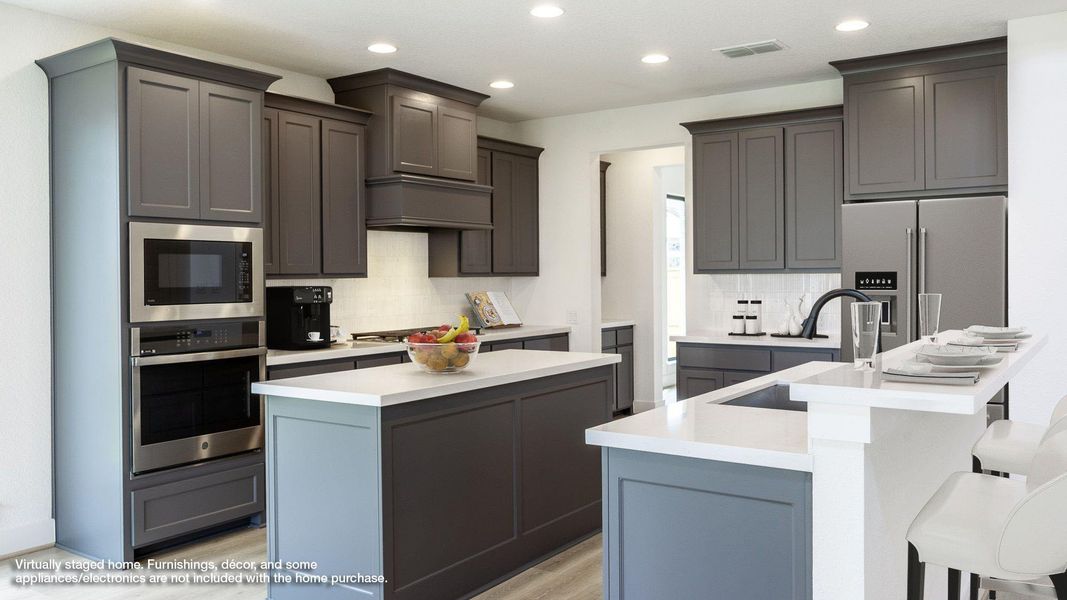 Kitchen with decorative backsplash, stainless steel appliances, recessed lighting, a kitchen breakfast bar, and gray cabinetry