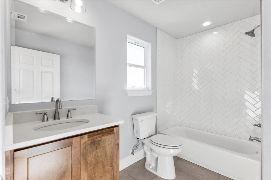 2nd Story Full bath featuring vanity, light tile patterned flooring, and bathtub / shower combination