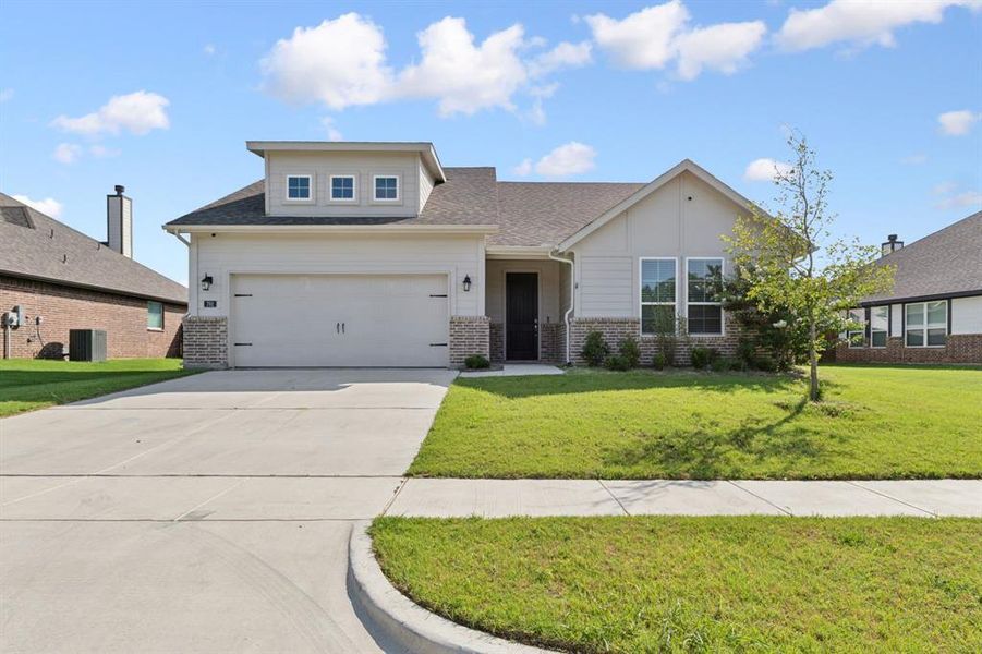 Front exterior of a new home in Holbrook Farm, Springtown, TX, highlighting curb appeal (Image 1). Front exterior of a new home in Holbrook Farm, Springtown, TX, highlighting curb appeal (Image 1).