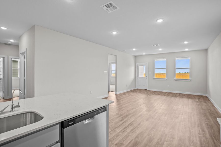 A kitchen with a wood floor. A kitchen with a wood floor.