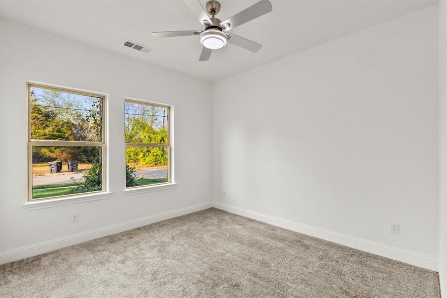 Empty room featuring carpet and ceiling fan