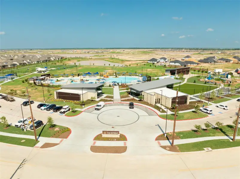 This aerial shot highlights the community's impressive features—clubhouse, lagoon, playgrounds, and more!