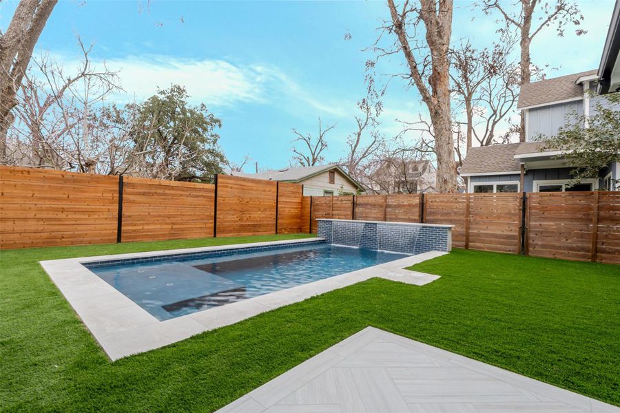 View of pool featuring a fenced backyard and patio surround