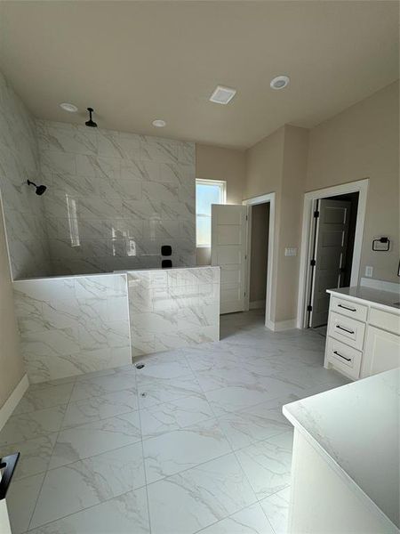 Full bath featuring light marble finish flooring, a marble finish shower, vanity, and recessed lighting Full bath featuring light marble finish flooring, a marble finish shower, vanity, and recessed lighting