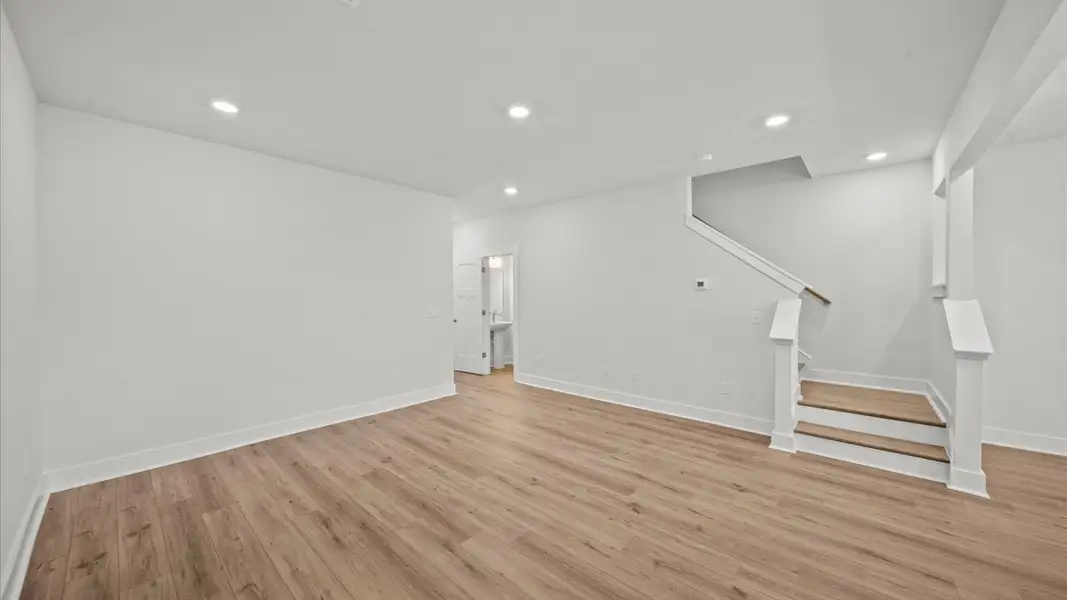 Elegant family room with hardwood flooring and open-concept flow in this first-class DRB Homes design