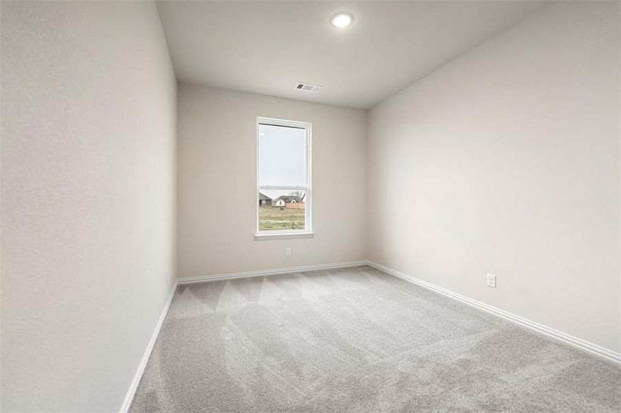 Empty room with carpet flooring and baseboards