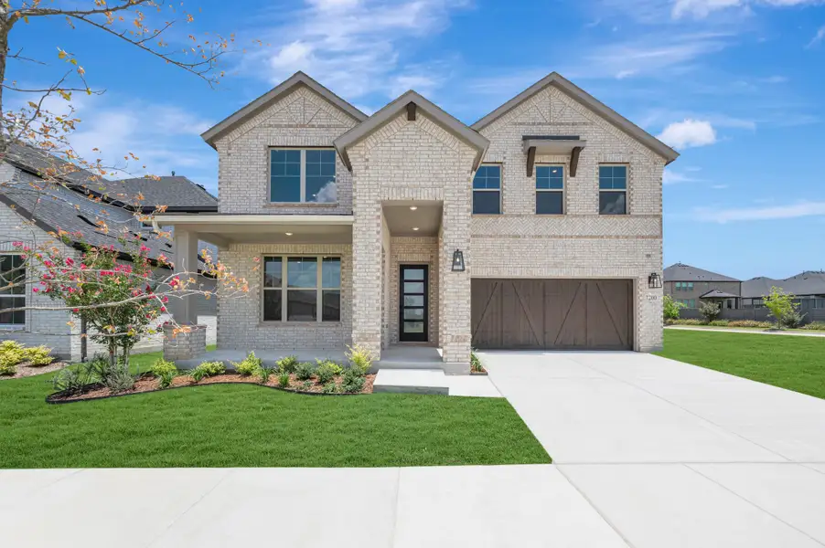 Front exterior of a new home in Union Park, Little Elm, TX, highlighting curb appeal (Image 1). Front exterior of a new home in Union Park, Little Elm, TX, highlighting curb appeal (Image 1).