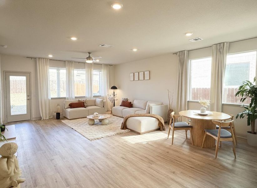 Living area with light wood-type flooring, ceiling fan, and recessed lighting