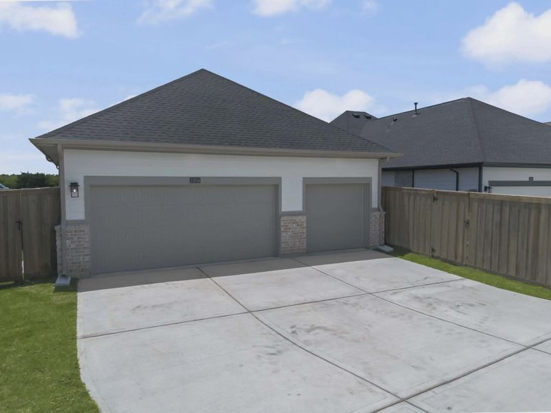 Representative exterior photo of a completed home built from the Mickelson by Chesmar Homes in Riceland Alley Loads, Mont Belvieu, TX (Image 39).