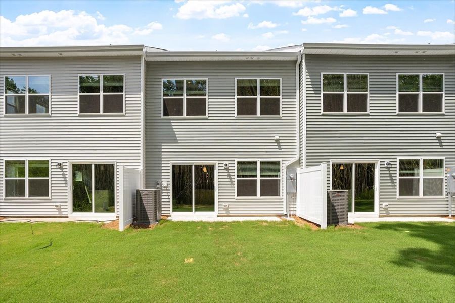 Exterior details and patio area of a home in West Main Townhomes, Sanford (Image 4).