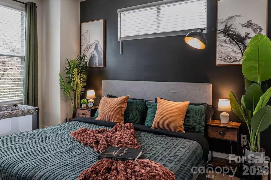 The spacious primary suite offers a peaceful retreat with abundant natural light, soaring ceilings, designer accent wall, and plenty of room to relax and unwind. The spacious primary suite offers a peaceful retreat with abundant natural light, soaring ceilings, designer accent wall, and plenty of room to relax and unwind.