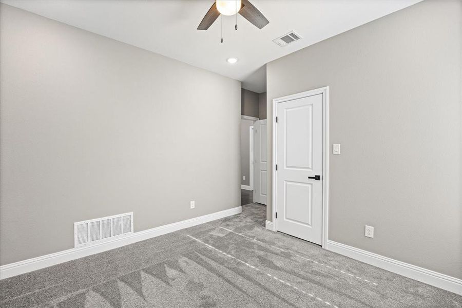 3rd bedroom featuring ceiling fan and carpet flooring