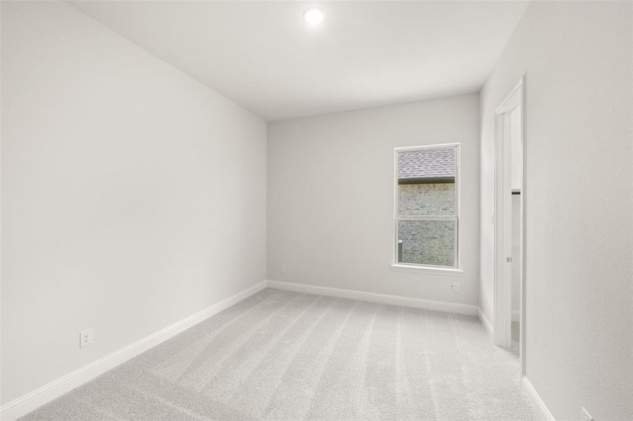 Empty room with baseboards and light colored carpet Empty room with baseboards and light colored carpet