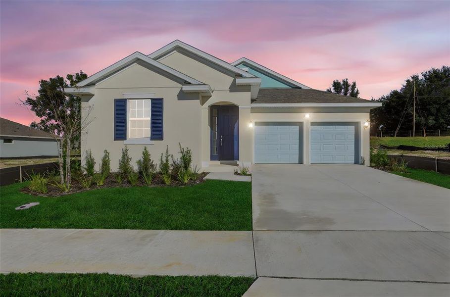 Front exterior of a new home in Crossroads at Kelly Park, Apopka, FL, highlighting curb appeal (Image 2). Front exterior of a new home in Crossroads at Kelly Park, Apopka, FL, highlighting curb appeal (Image 2).