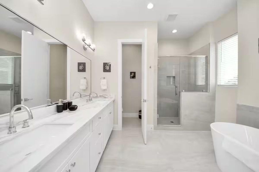 The primary bath gives you both options: a freestanding soaking tub when you want to unwind and a separate walk-in shower for the everyday routine.