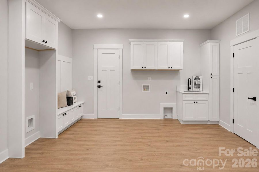 Laundry comes with drop zone, sink & space for extra fridge.