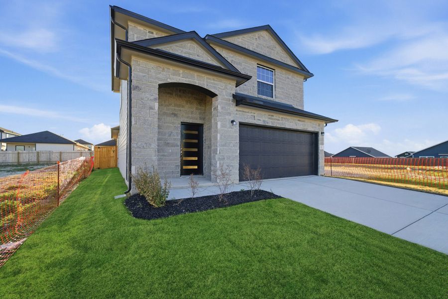 Front exterior of a new home in Cool Water, Jarrell, TX, highlighting curb appeal (Image 2). Front exterior of a new home in Cool Water, Jarrell, TX, highlighting curb appeal (Image 2).