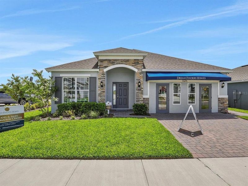 Front exterior of a new home in Cypress Park Estates, Haines City, FL, highlighting curb appeal (Image 7).