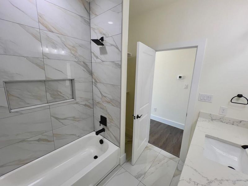 Bathroom with vanity and tiled shower / bath combo