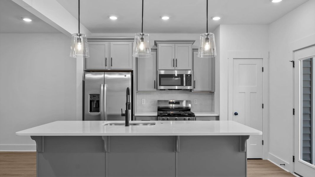 Notable 9-foot island provides generous prep and gathering space in this thoughtfully designed kitchen