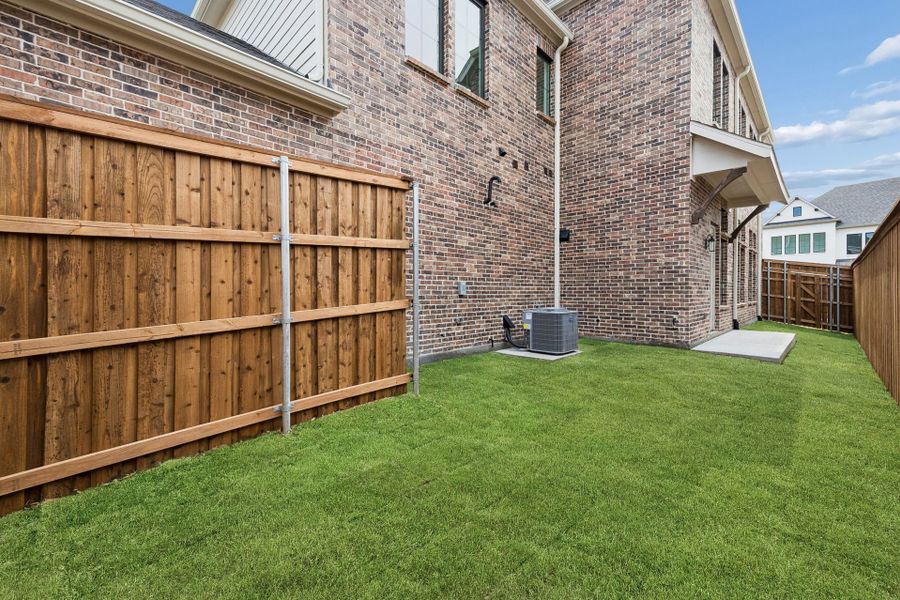 Exterior details and patio area of a home in Newman Village Townhomes, Frisco (Image 4).