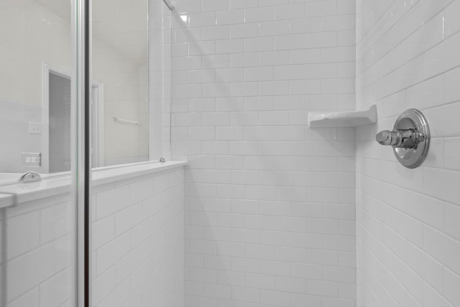 The separate glass-enclosed shower features sleek tile walls and modern fixtures, giving a crisp, fresh look to the primary bath. It’s the ideal combination of style and convenience for everyday living. The separate glass-enclosed shower features sleek tile walls and modern fixtures, giving a crisp, fresh look to the primary bath. It’s the ideal combination of style and convenience for everyday living.