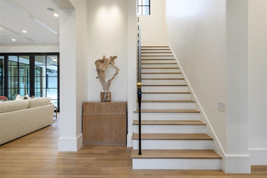Stairs featuring wood finished floors and recessed lighting Stairs featuring wood finished floors and recessed lighting