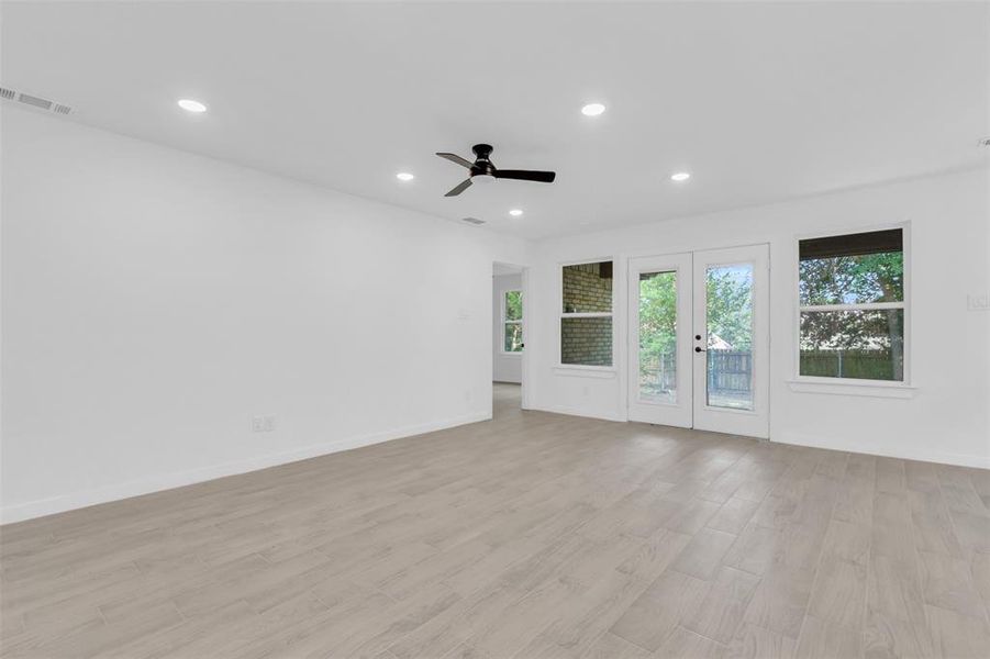 Empty room with recessed lighting, a ceiling fan, light wood finished floors, and french doors